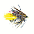 Fishing fly with yellow and brown colors on a white background