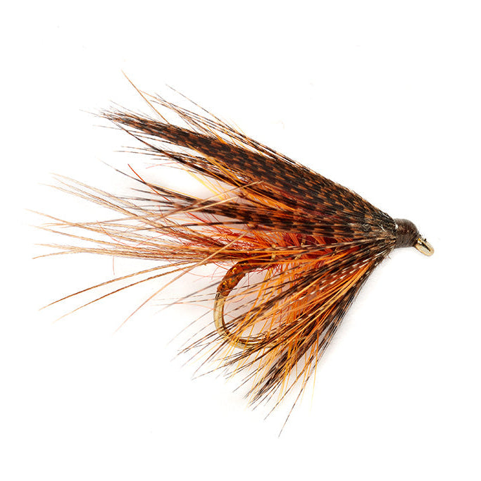 Fishing fly with brown and orange feathers on a white background