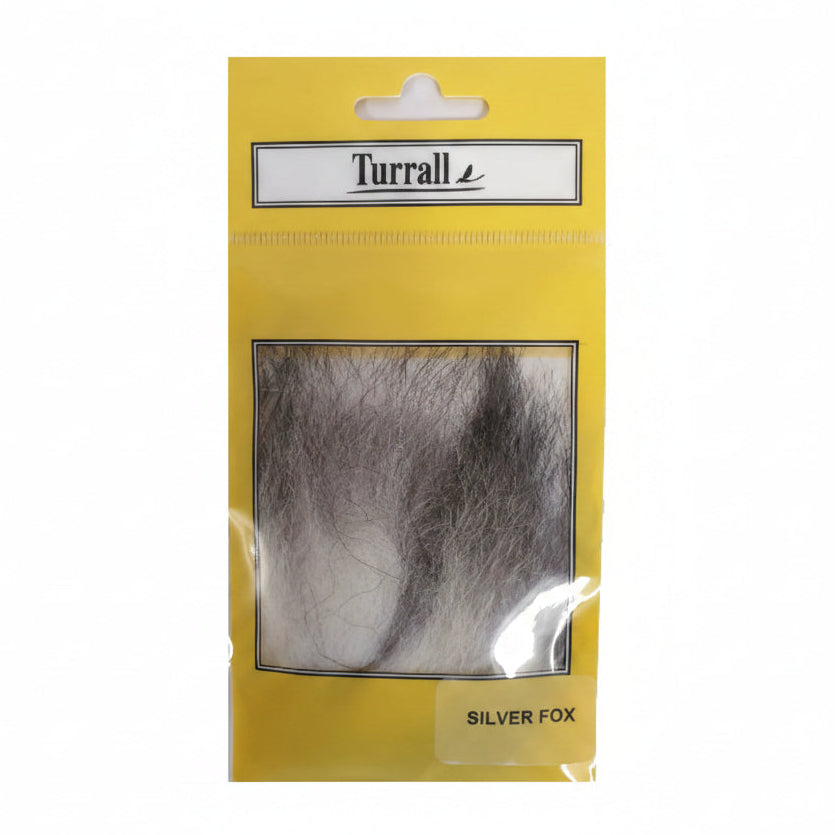 Packaged silver fox fur by Turrall on a yellow backing card, with a clear window showing the dark gray to silver faux fur and a label reading 'SILVER FOX'.