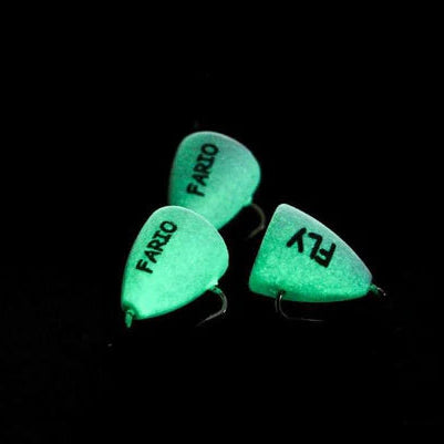 Three green fishing lures labeled 'Fario' and 'Fly' on a black background