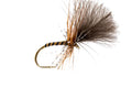 Fly fishing fly with brown and black feathers on a white background
